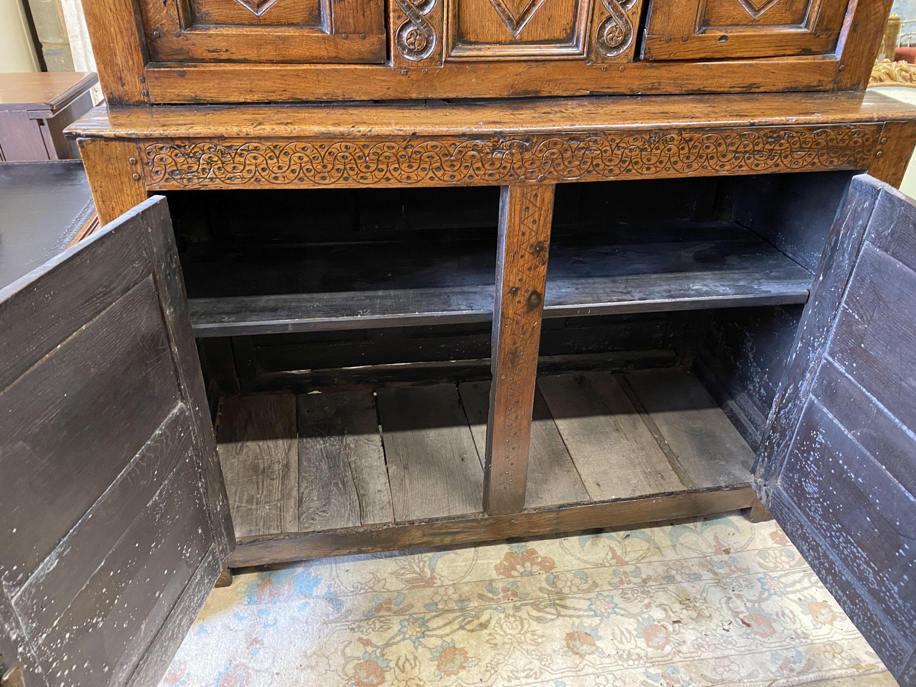 A Charles II oak court cupboard, dated 1673, width 140cm, depth 52cm, height 148cm